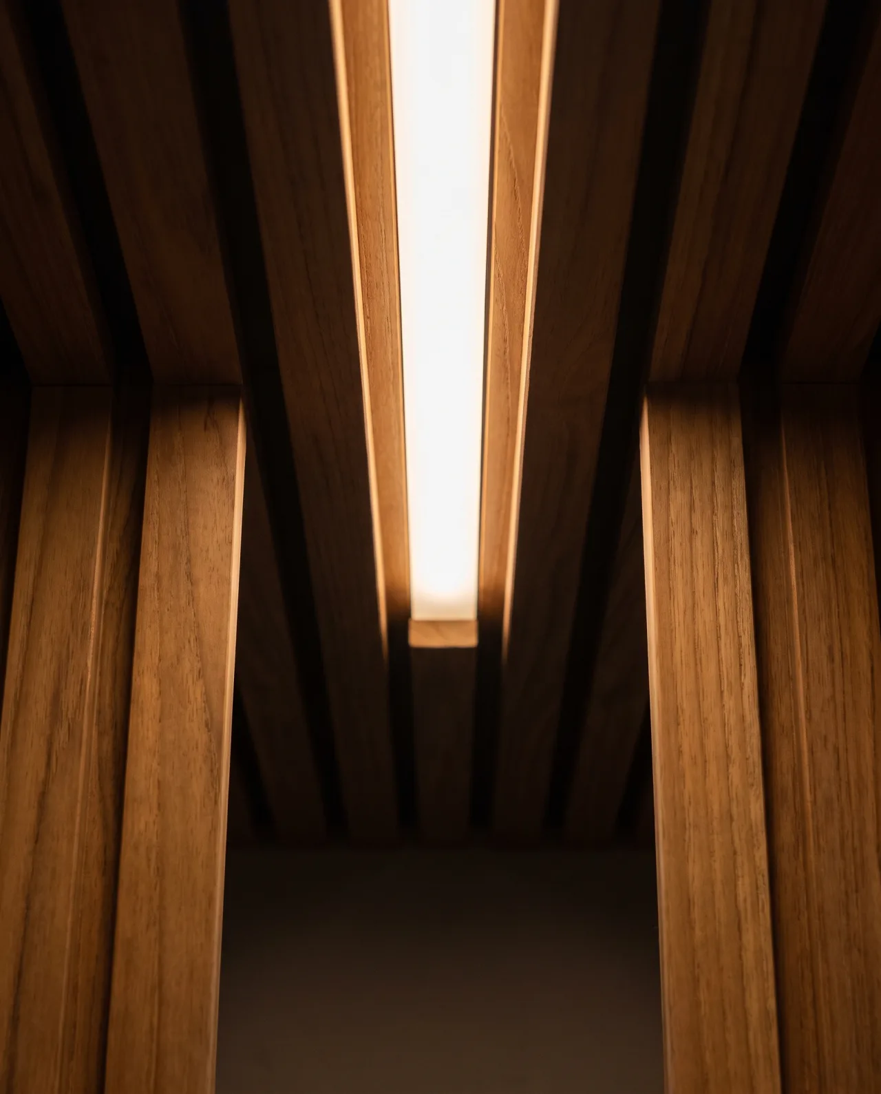 Wood slat ceiling detail showing joinery and an integrated light fixture