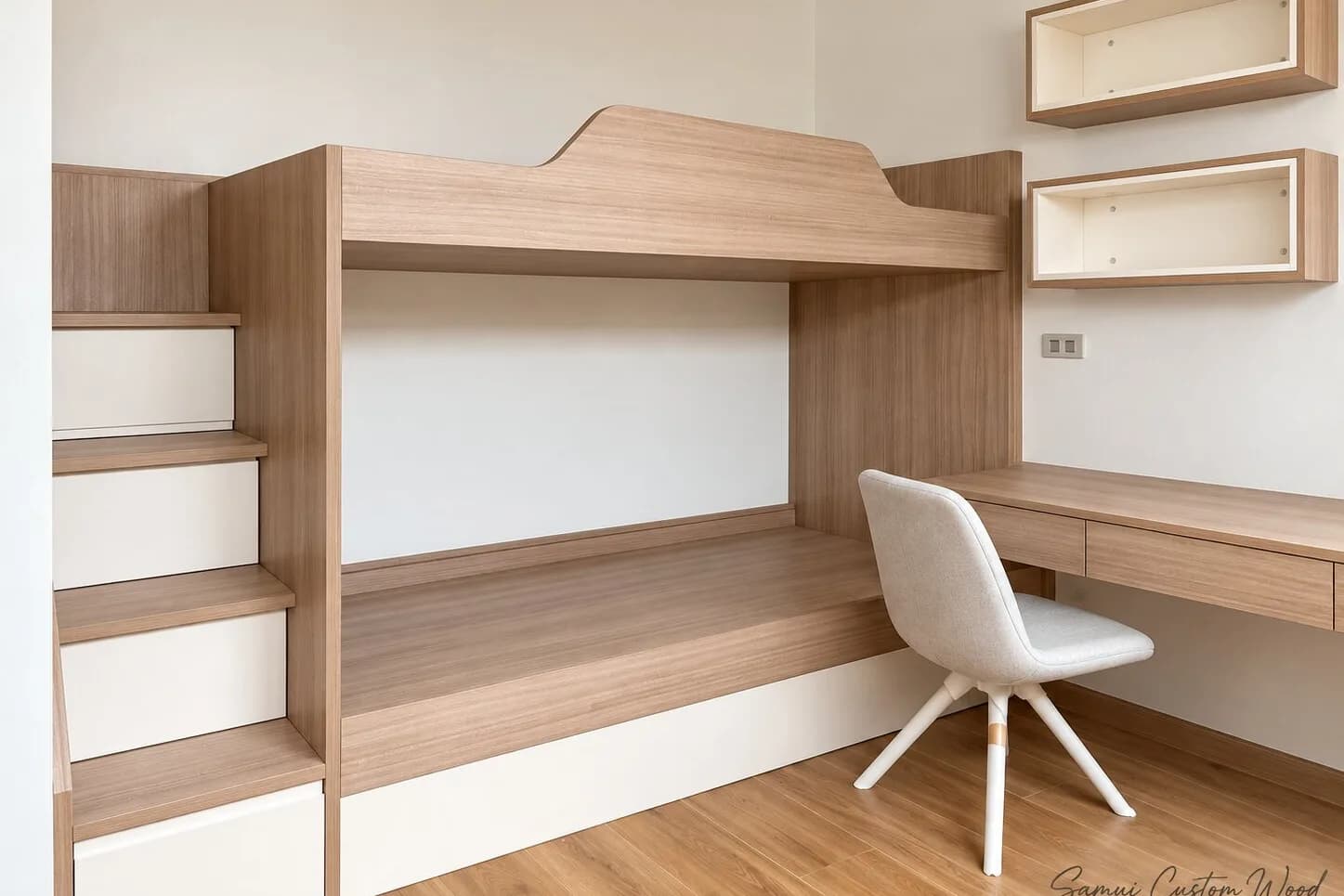 Kids' room with fitted bunk bed, storage stairs, desk and wall shelves